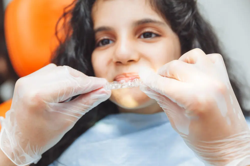 teen-girl-holding-braces-dentist-puts-braces-girl-dental-care-orthodontic-concept
